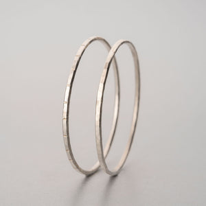 Two hand beaten silver bangles
