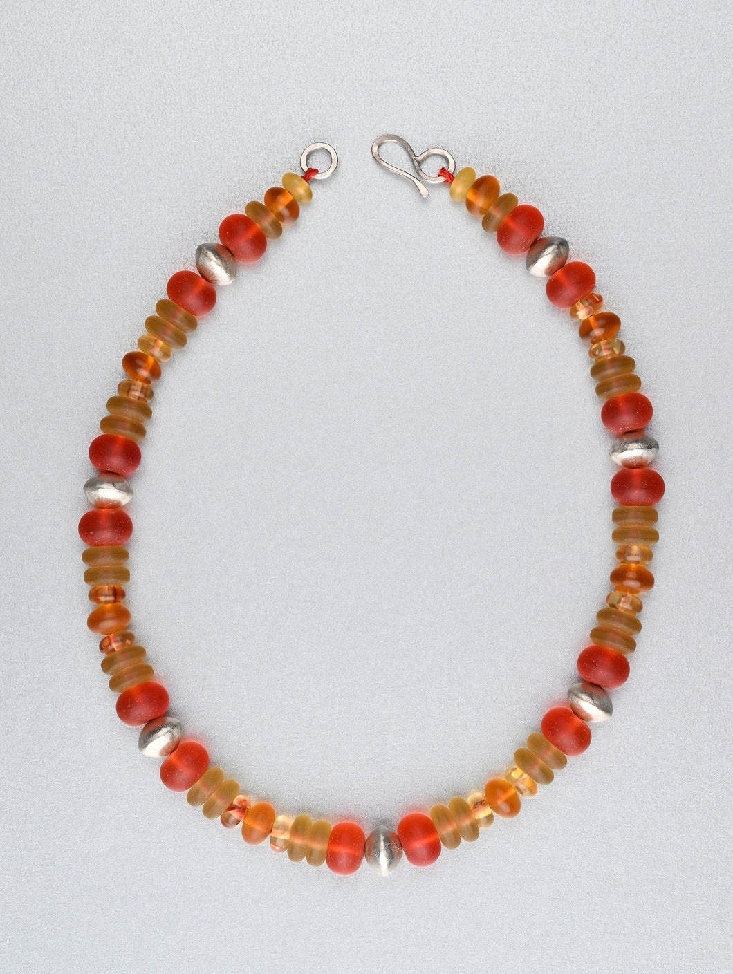 Beaded necklace with sea glass, amber and silver.