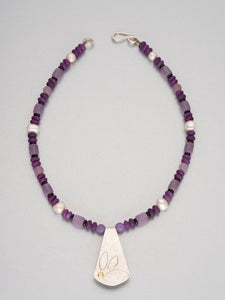 Beaded necklace with sea glass, semi-precious stones and a silver pendant with 18 ct gold detail.